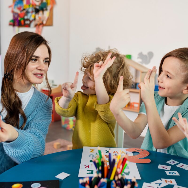 medium shot kids teacher table 3