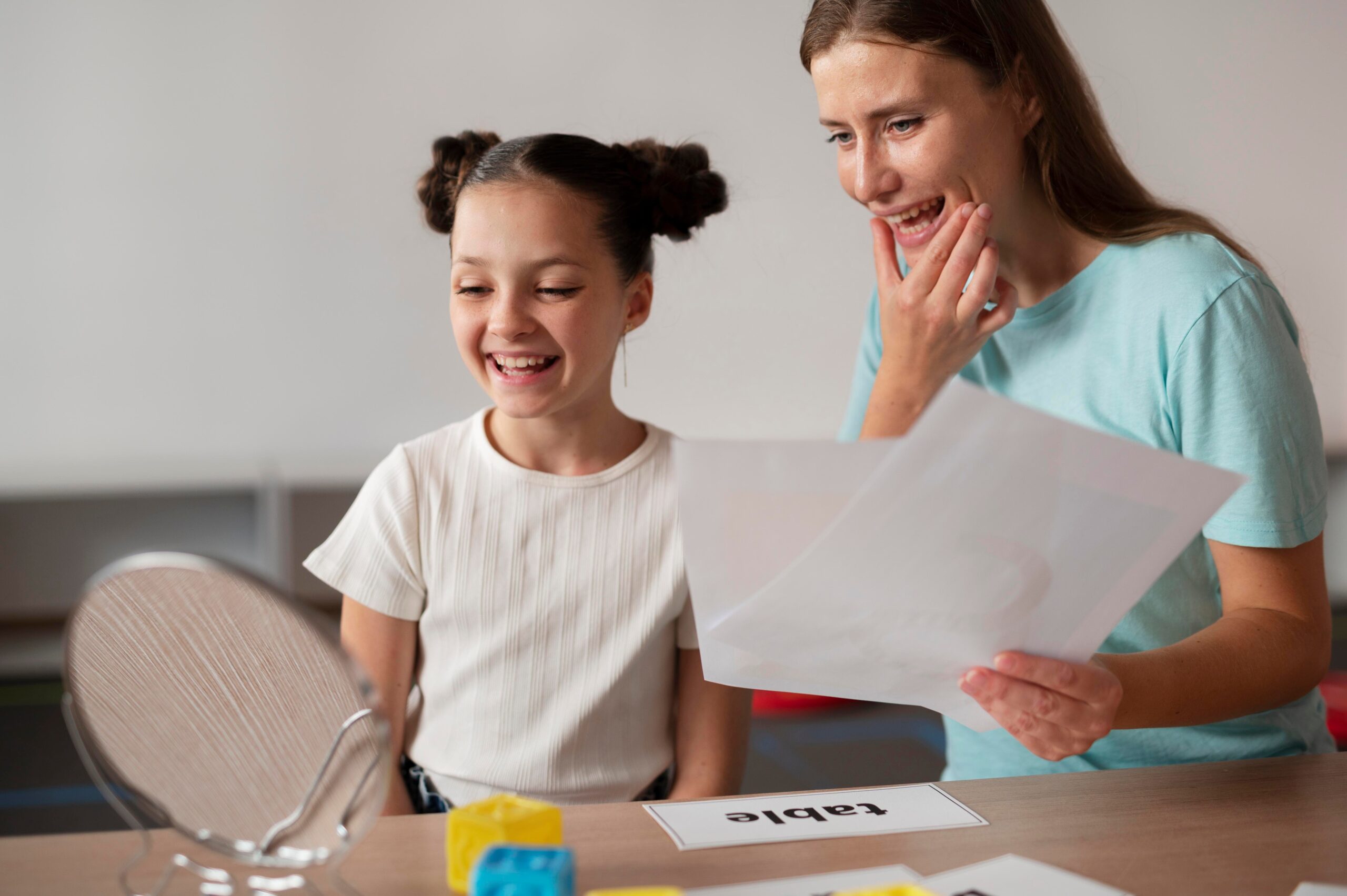 psychologist helping little girl speech therapy indoors 2 1 scaled