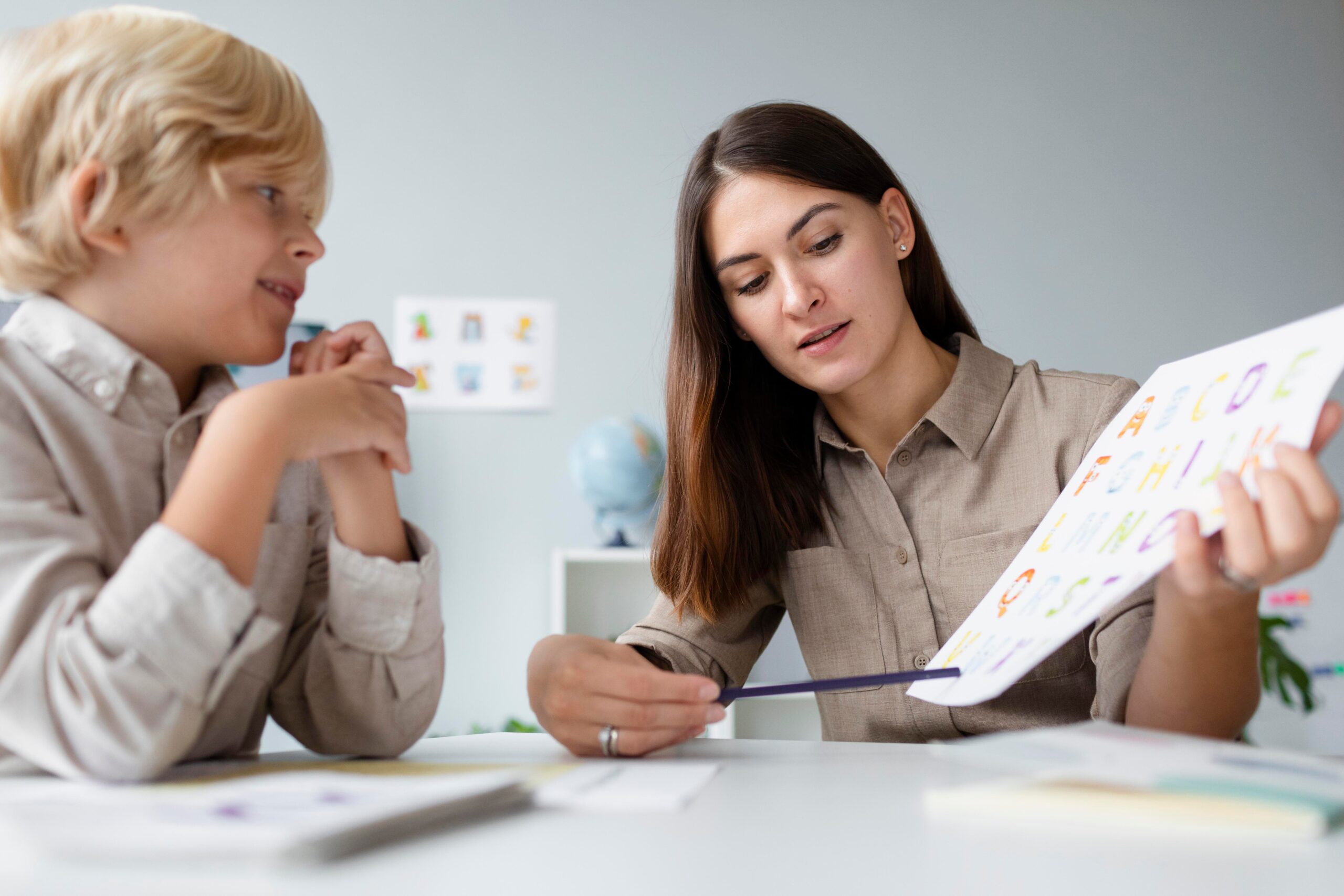 woman doing speech therapy with little blonde boy 1 scaled